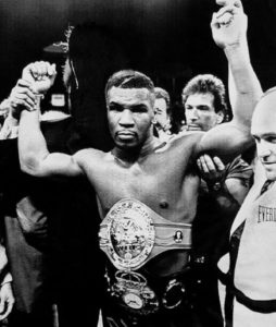 Mike Tyson lifts arm after win
