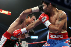 Juan Manuel Marquez punches Manny Pacquiao in their fourth fight