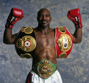 Evander Holyfield with championship belts