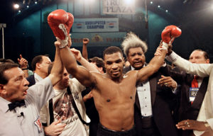 Mike Tyson celebrates after Michael Spinks win with Don King and Kevin Rooney