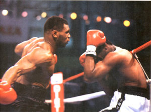 Mike Tyson throws a punch at Michael Spinks