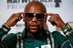 Floyd Mayweather points to head at press conference