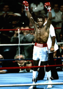 Sugar Ray Robinson in the ring raising his arms 