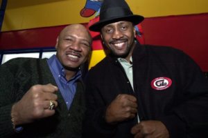 Older Marvin Hagler and Thomas Hearns smile and pose for a picture