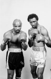 Marvin Hagler and Thomas Hearns striek a fighting pose together