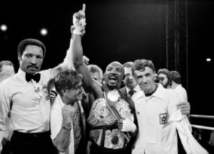 Marvin Hagler celebrates win with trainer Petroneli and referee Richard Steele
