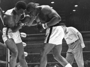 Sonny Liston punches Cassius Clay on the ropes