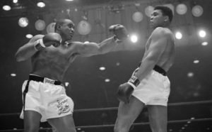 Cassius Clay avoids a punch from Sonny Liston